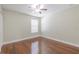 Simple bedroom featuring a window, fan and hardwood floors at 20404 Autumn Fern Ave, Tampa, FL 33647