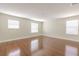 Large bedroom with three windows, wood floors, base trim, and neutral paint at 20404 Autumn Fern Ave, Tampa, FL 33647