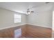 Bedroom featuring modern floors, neutral paint, ceiling fan, base trim and a window for natural light at 20404 Autumn Fern Ave, Tampa, FL 33647