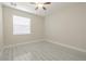 A cozy bedroom offers a ceiling fan and white wood-look flooring at 20404 Autumn Fern Ave, Tampa, FL 33647