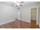Bedroom featuring hardwood flooring, a ceiling fan, and ensuite closet at 20404 Autumn Fern Ave, Tampa, FL 33647