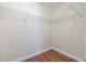 Walk in closet features a wire shelf system and hardwood flooring at 20404 Autumn Fern Ave, Tampa, FL 33647