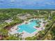 This home features access to a vast community pool area with seating, palm trees, and a clubhouse at 20404 Autumn Fern Ave, Tampa, FL 33647