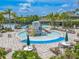 This home features access to a wonderful community pool, water slides, and seating areas under shady trees at 20404 Autumn Fern Ave, Tampa, FL 33647