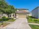 Two-story home boasts a spacious driveway, lush lawn and manicured landscaping at 20404 Autumn Fern Ave, Tampa, FL 33647