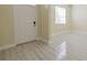 Inviting foyer with white door, light walls, and contemporary tile flooring. Lots of natural light at 20404 Autumn Fern Ave, Tampa, FL 33647