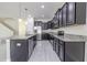 Well-equipped kitchen featuring an island, granite countertops, and stainless steel appliances at 20404 Autumn Fern Ave, Tampa, FL 33647