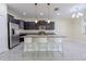 Open concept kitchen with granite island, stainless steel appliances, and bar stool seating at 20404 Autumn Fern Ave, Tampa, FL 33647