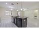 Kitchen island featuring granite countertops, seating and views into the living area at 20404 Autumn Fern Ave, Tampa, FL 33647