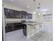 Kitchen area featuring granite island, stainless steel appliances, and pendant lighting at 20404 Autumn Fern Ave, Tampa, FL 33647