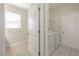 Bright laundry room with tile flooring, white washer and dryer, and window providing natural light at 20404 Autumn Fern Ave, Tampa, FL 33647
