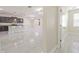Bright, open-concept living room with white flooring and granite countertops at 20404 Autumn Fern Ave, Tampa, FL 33647