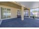 A covered patio with a dark blue rug, furniture, and sliding glass doors at 20404 Autumn Fern Ave, Tampa, FL 33647