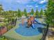 Community playground with slides, climbing structures, and soft, colorful ground coverings at 20404 Autumn Fern Ave, Tampa, FL 33647