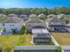 This home features a screened-in patio, spacious backyard, and views of the surrounding houses and trees at 20404 Autumn Fern Ave, Tampa, FL 33647