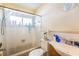 Bright bathroom with a shower-tub combo, white tile, and natural light at 2078 Shadow Ln, Clearwater, FL 33763