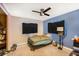 Bedroom with a ceiling fan and a bed covered with a blue blanket at 2078 Shadow Ln, Clearwater, FL 33763