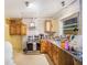 Kitchen needing renovation with wooden cabinets, stainless steel appliances, and work space at 2078 Shadow Ln, Clearwater, FL 33763