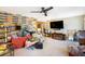 Spacious living room featuring a decorative brick wall, ceiling fan, and entertainment center at 2078 Shadow Ln, Clearwater, FL 33763