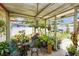 Enclosed patio with plants and outdoor furniture at 2078 Shadow Ln, Clearwater, FL 33763
