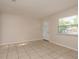 Bright living room featuring tiled flooring, neutral walls, and a well-lit entrance at 2137 Victoria Dr, Clearwater, FL 33763
