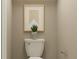Bathroom showcases a toilet with modern decor and neutral color walls and a small plant at 2288 Blue Grosbeak Pl, Wimauma, FL 33598