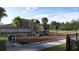 Community playground featuring slides, swings, and a secure fenced area for Gathering fun at 2288 Blue Grosbeak Pl, Wimauma, FL 33598