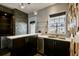 Stylish bar area with stone accent wall and a sink at 2305 Victoria Gardens Ln, Tampa, FL 33609