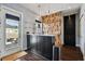 Modern bar area with a wood accent wall and stylish lighting at 2305 Victoria Gardens Ln, Tampa, FL 33609