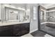 Modern bathroom featuring a large vanity, walk-in shower, and stylish tile accents at 2305 Victoria Gardens Ln, Tampa, FL 33609