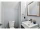 Stylish half bathroom featuring a modern sink, vanity, toilet, and gray walls at 2305 Victoria Gardens Ln, Tampa, FL 33609