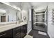 Modern bathroom featuring a glass-enclosed shower, marble countertop, and stylish fixtures at 2305 Victoria Gardens Ln, Tampa, FL 33609