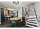 Elegant dining area with unique lighting, round table, and stairway access at 2305 Victoria Gardens Ln, Tampa, FL 33609