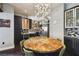 Modern dining area with a unique chandelier and a view into the stylish kitchen at 2305 Victoria Gardens Ln, Tampa, FL 33609