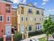 Well-manicured two-story townhome featuring decorative balconies and colorful facade at 2305 Victoria Gardens Ln, Tampa, FL 33609