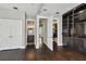 Hallway with hardwood floors and open doorway to the living room and bathroom at 2305 Victoria Gardens Ln, Tampa, FL 33609
