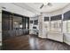 Spacious living room boasting hardwood floors, custom built-ins, and multiple windows at 2305 Victoria Gardens Ln, Tampa, FL 33609