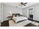 Relaxing primary bedroom featuring hardwood floors, large windows, and neutral decor at 2305 Victoria Gardens Ln, Tampa, FL 33609