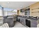 Modern outdoor kitchen featuring a built-in grill, stylish bar area, and mounted television at 2305 Victoria Gardens Ln, Tampa, FL 33609