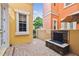 Cozy outdoor patio with brick pavers and a charming stone fireplace at 2305 Victoria Gardens Ln, Tampa, FL 33609
