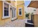 Inviting patio with brick pavers, stone fireplace, and views of the surrounding building at 2305 Victoria Gardens Ln, Tampa, FL 33609