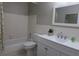 Bright bathroom features a tiled tub and shower, a white vanity, and a mirrored medicine cabinet at 2360 World Parkway Blvd # 36, Clearwater, FL 33763
