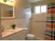 Bright bathroom features a shower/tub combo with a colorful curtain and tiled walls at 2360 World Parkway Blvd # 36, Clearwater, FL 33763