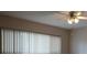 Light-filled bedroom featuring vertical blinds, a ceiling fan, and neutral walls at 2360 World Parkway Blvd # 36, Clearwater, FL 33763