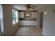 Bright dining area with built-in cabinets, drawers, tiled floors, modern lighting, and views of the kitchen at 2360 World Parkway Blvd # 36, Clearwater, FL 33763