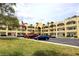 Bright condo complex with a gold dome, manicured lawns, ample parking, and the American flag waving proudly at 2360 World Parkway Blvd # 36, Clearwater, FL 33763