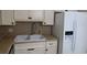 Kitchen sink and counter featuring stainless steel appliances, plus white cabinetry providing plenty of storage space at 2360 World Parkway Blvd # 36, Clearwater, FL 33763