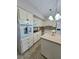 Well-lit eat-in kitchen with a center island and white appliances at 2360 World Parkway Blvd # 36, Clearwater, FL 33763