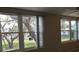 Bright living room featuring large windows with scenic views of mature trees at 2360 World Parkway Blvd # 36, Clearwater, FL 33763