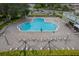 Overhead view of a flower-shaped pool with lounge chairs surrounding it, and a pool cleaner in the water at 2360 World Parkway Blvd # 36, Clearwater, FL 33763